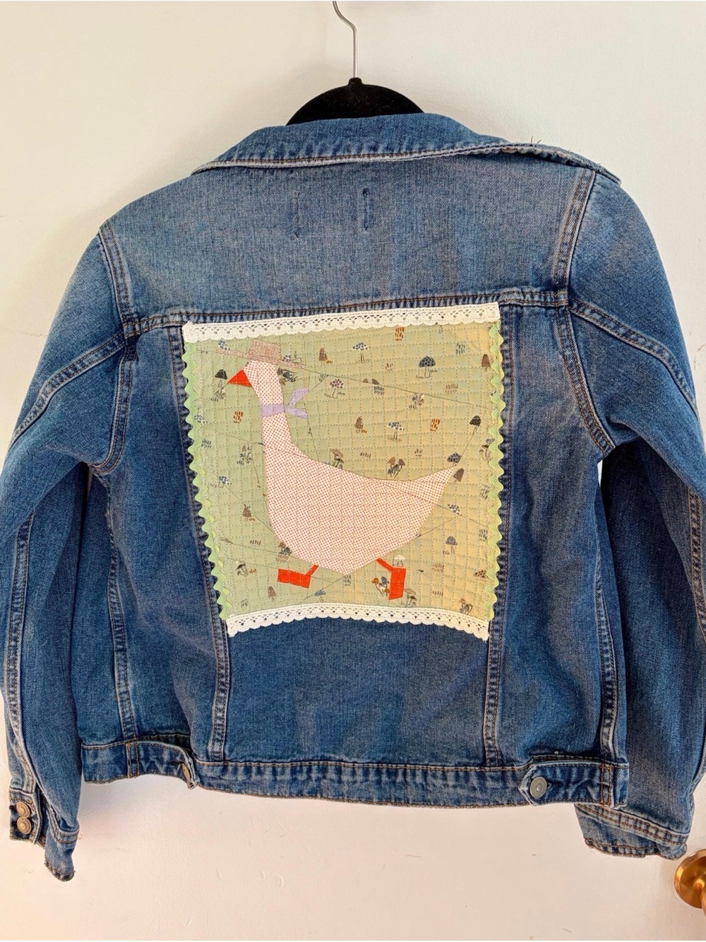 Upcycled Jean jacket with a quilted cowboy goose with lace on the back size smal